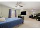Bedroom with large bed, ceiling fan, neutral carpet, and a large window with blinds at 7980 Bradford Ln, Denver, NC 28037