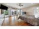 Spacious bedroom with hardwood floors, a ceiling fan, balcony access, and ensuite bathroom at 7980 Bradford Ln, Denver, NC 28037