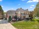 Beautiful brick home with a swimming pool, a manicured lawn, mature trees and colorful landscaping at 7980 Bradford Ln, Denver, NC 28037