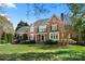 Charming brick home featuring a well-manicured lawn and beautiful landscaping at 7980 Bradford Ln, Denver, NC 28037
