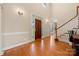 Welcoming foyer with hardwood floors, a grand staircase, and elegant lighting fixtures at 7980 Bradford Ln, Denver, NC 28037