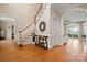 Elegant foyer featuring hardwood floors, staircase, and access to a living area with lake views at 7980 Bradford Ln, Denver, NC 28037