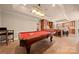 Spacious game room features a billiard table with adjacent kitchenette and custom cabinetry at 7980 Bradford Ln, Denver, NC 28037
