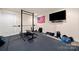 Home gym with weight lifting equipment and television for entertainment while exercising at 7980 Bradford Ln, Denver, NC 28037