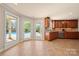 Well-lit kitchen boasts ample cabinet space and a view of the pool and patio area through large windows at 7980 Bradford Ln, Denver, NC 28037