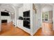 Kitchen with white cabinets and stainless appliances seen from hallway with oven and microwave at 7980 Bradford Ln, Denver, NC 28037