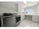 Laundry room with stainless steel washer and dryer, window, and plenty of counter space at 7980 Bradford Ln, Denver, NC 28037