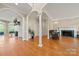Spacious living room featuring hardwood floors, arched doorways, columns, and a fireplace at 7980 Bradford Ln, Denver, NC 28037