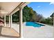 The beautiful pool and patio area of this home are framed by mature trees for privacy and shade at 7980 Bradford Ln, Denver, NC 28037