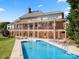 A stunning outdoor pool is perfectly positioned adjacent to the home, offering leisure and scenic appeal at 7980 Bradford Ln, Denver, NC 28037