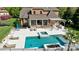 An aerial view of an estate home with a pool, spa, and screened porch at 819 Beauhaven Ln, Waxhaw, NC 28173