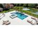 Aerial view of a luxurious pool with a hot tub overlooking a gorgeous backyard pond at 819 Beauhaven Ln, Waxhaw, NC 28173