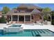 A backyard featuring a pool, spa, screened porch, outdoor kitchen, and brick home at 819 Beauhaven Ln, Waxhaw, NC 28173