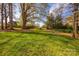 A beautiful backyard with a large lawn, trees, and lush landscaping at 819 Beauhaven Ln, Waxhaw, NC 28173