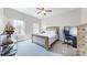 Bright bedroom featuring a bed, a desk, and large windows for natural light at 819 Beauhaven Ln, Waxhaw, NC 28173