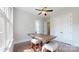 Bright dining room with a modern ceiling fan, hardwood floors, and large windows at 819 Beauhaven Ln, Waxhaw, NC 28173