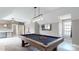 Game room complete with a pool table, TV, and a bar area for refreshments and entertaining at 819 Beauhaven Ln, Waxhaw, NC 28173