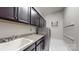 This laundry room features sleek cabinetry, granite countertops, a utility sink, and modern washer/dryer at 819 Beauhaven Ln, Waxhaw, NC 28173