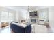 Bright and inviting living room with a stone fireplace, hardwood floors, and multiple windows at 819 Beauhaven Ln, Waxhaw, NC 28173