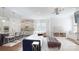 Open-concept living space with a kitchen island, comfortable seating, and a cozy fireplace at 819 Beauhaven Ln, Waxhaw, NC 28173