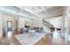 Elegant living room with coffered ceilings, a modern chandelier, and hardwood floors at 819 Beauhaven Ln, Waxhaw, NC 28173