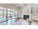 Bright living room featuring a fireplace, built-in shelving, and sliding doors leading to an outdoor porch at 819 Beauhaven Ln, Waxhaw, NC 28173