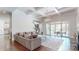Bright living room with coffered ceilings, hardwood floors, fireplace, and access to a covered patio at 819 Beauhaven Ln, Waxhaw, NC 28173