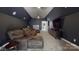 Home theater room with large screen TV, comfortable seating, and dark colors for an immersive experience at 819 Beauhaven Ln, Waxhaw, NC 28173