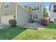Beautiful backyard with stone patio, lush lawn, and flowering bushes at 8311 Camberly Rd, Huntersville, NC 28078