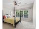 Bedroom with a four-poster bed and large windows providing abundant natural light at 8311 Camberly Rd, Huntersville, NC 28078