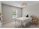 Cozy bedroom features a metal bed frame and a bright window at 8311 Camberly Rd, Huntersville, NC 28078