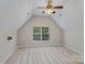 Attic bedroom with vaulted ceiling, neutral walls and carpet and a ceiling fan at 8311 Camberly Rd, Huntersville, NC 28078