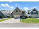 Inviting home with a well-manicured front yard, long driveway, and attached garage at 8311 Camberly Rd, Huntersville, NC 28078