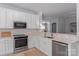 Bright kitchen features stainless steel appliances, white cabinetry, and an open view to the living room at 8311 Camberly Rd, Huntersville, NC 28078