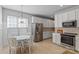 Eat-in kitchen with stainless steel refrigerator, oven, and light-filled window adjacent to the dining area at 8311 Camberly Rd, Huntersville, NC 28078