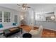 Open-concept living room with hardwood floors, neutral walls, and a glimpse into the kitchen area at 8311 Camberly Rd, Huntersville, NC 28078