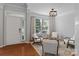 Inviting living room with hardwood floors, natural light, and a welcoming seating area by the front door at 8311 Camberly Rd, Huntersville, NC 28078