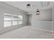 Bright loft area with large window, neutral paint, carpet and ample space for relaxing or entertaining at 8311 Camberly Rd, Huntersville, NC 28078