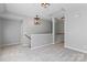 Inviting loft area with soft carpeting, stylish light fixtures, and a staircase view at 8311 Camberly Rd, Huntersville, NC 28078