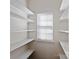 Walk-in Pantry with ample shelving for organized storage and a window for natural light at 8311 Camberly Rd, Huntersville, NC 28078