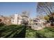 Back of house overlooking swimming pool and patio, surrounded by mature trees and a well maintained lawn at 8718 Canter Post Dr, Charlotte, NC 28216