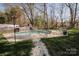 A serene backyard with a pool and lush landscaping provides a private oasis for relaxation and recreation at 8718 Canter Post Dr, Charlotte, NC 28216