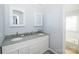 Bathroom features a dual sink vanity, granite countertop, and a soaking tub at 8718 Canter Post Dr, Charlotte, NC 28216