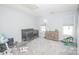 Bright bedroom featuring neutral walls, carpet, crib, and reading chair at 8718 Canter Post Dr, Charlotte, NC 28216