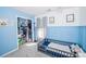 A bright bedroom features blue wall trim, natural light and closet shelving at 8718 Canter Post Dr, Charlotte, NC 28216