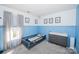 A bright bedroom features blue wall trim, natural light and toddler furnishings at 8718 Canter Post Dr, Charlotte, NC 28216