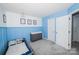 A bright bedroom features blue wall trim, neutral walls, and bright natural light at 8718 Canter Post Dr, Charlotte, NC 28216