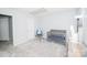 Bright bedroom featuring neutral walls, carpet, crib, and reading chair at 8718 Canter Post Dr, Charlotte, NC 28216