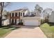 Inviting two-story home with a two-car garage, a lush green lawn and manicured landscaping at 8718 Canter Post Dr, Charlotte, NC 28216
