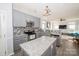 Well-appointed kitchen featuring gray cabinets, stainless steel appliances, and granite countertops at 8718 Canter Post Dr, Charlotte, NC 28216